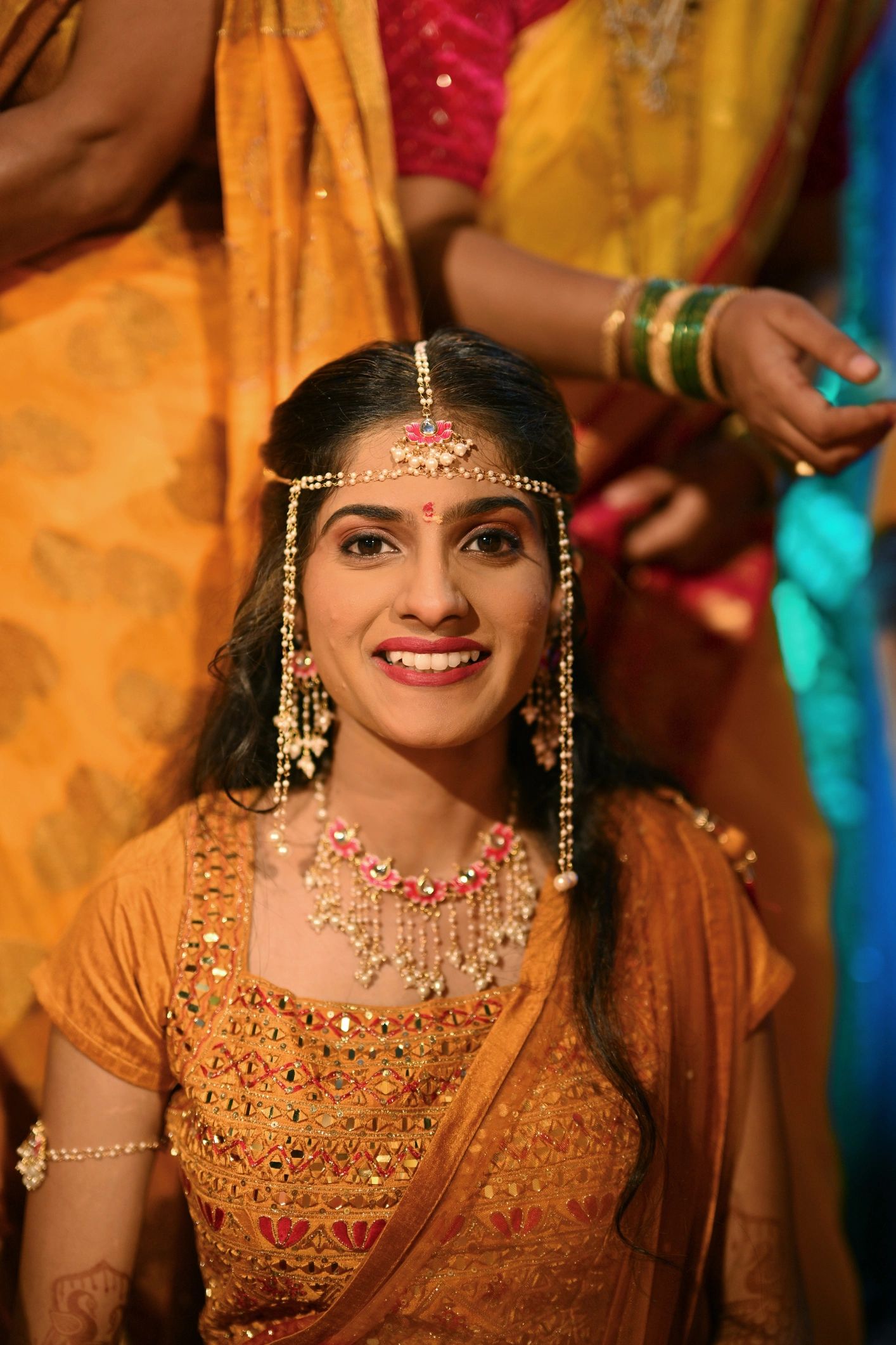 Indian smiling bride with Mundawali sacred thread during haldi ceremony